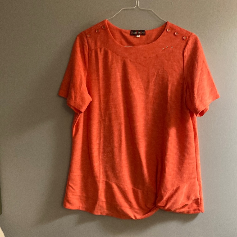 Claire France orange with white smears across the blouse